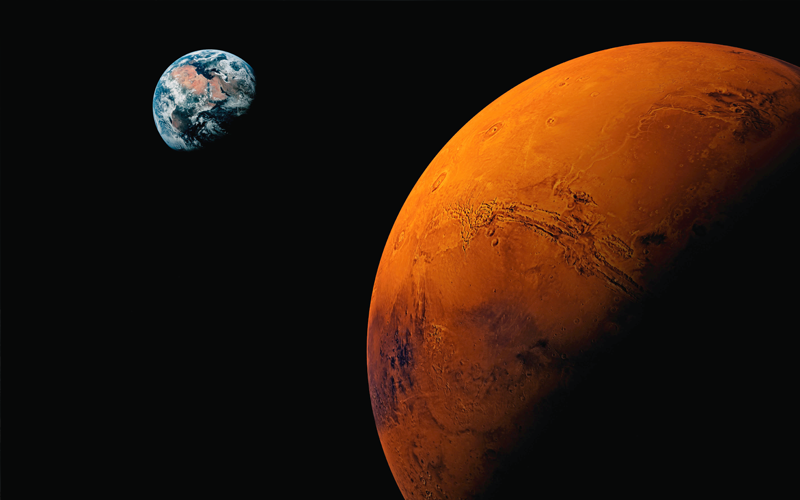 Mars and Earth juxtaposed against the darkness of space.